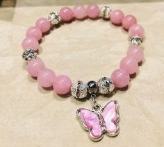 This lovely 8mm pink rhodonite beaded bracelet embodies the sweetness and charm of a blooming garden. The soft, blush-like hue of the rhodonite stones exudes a gentle, feminine elegance, while the delicate beads add a touch of whimsy and playfulness. Each stone is carefully selected to showcase its natural beauty, creating a bracelet that radiates warmth and tenderness. Perfect for those who appreciate the beauty of soft colors and delicate design. Pink Charm Bracelet With 8mm Beads, Pink Natural Stones Crystal Bracelet, Pink Opal Beaded Bracelets As Gift, Pink Rose Quartz Round Beaded Bracelets, Pink Rose Quartz Round Stretch Bracelet, Pink Opal Beaded Bracelets With Round Beads As Gift, Pink Rose Quartz Stretch Bracelet, Spiritual Pink Round Stretch Bracelet, Elegant Pink Stretch Bracelet With Natural Stones