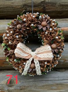 a pine cone wreath hanging on a wooden wall