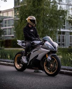 a man sitting on top of a silver motorcycle