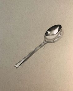 a silver spoon sitting on top of a counter