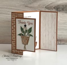 an open card with a potted plant on it