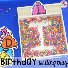 a birthday cake with sprinkles in a box next to a cut out number