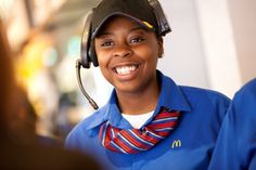 a woman wearing a headset and smiling for the camera