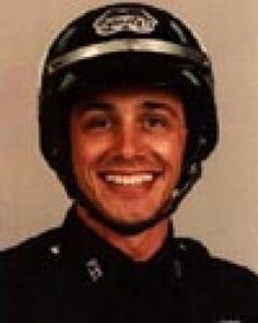 a police officer wearing a helmet and smiling