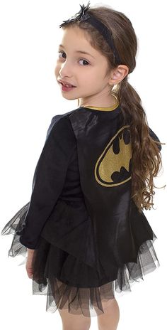 PRICES MAY VARY. Long-sleeve Batgirl costume dress features the Bat symbol on the chest and ballerina-style tutu skirt. Stretchy knit blend fabric offers easy movement Removable Batgirl cape is included to create a complete superhero look. Superhero cape attaches to the dress via hook-and-loop fasteners at the upper back Matching stretch headband is also included. Bow with Bat logo embellishes the headband Toddler girls' Batman costume pulls on over the head for easy dressing The ultimate Batgirl costume to wear for photos, trick-or-treating on Halloween, playing around the house, and when they’re out saving the day Dress your little girl in homage to Batgirl with this photo-ready Tutu Dress. 

 Long-sleeve ballerina dress sports a superhero design with logo emblem on the chest. Dress also Toddler Superhero Costume, Bat Logo, Costume Tutu, Bat Symbol, Superhero Cape, Batgirl Costume, Batman Costume, Superhero Costume, Ballerina Style