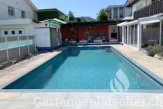 an empty swimming pool in the middle of a backyard