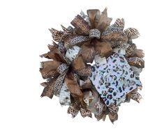 a leopard print wreath with brown and white bows