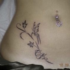 a woman's stomach with a tattoo on it that reads love and has flowers growing out of it