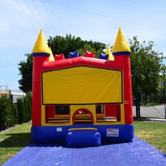 an inflatable bounce house with a slide on top