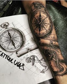 a man with a tattoo on his arm has a compass and an arrow