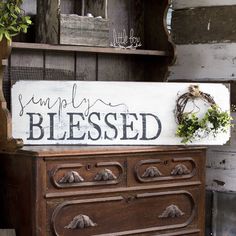 an old dresser with a sign that says simply blessing