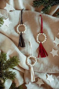 some ornaments are hanging from the branches of a christmas tree on a blanket with other decorations