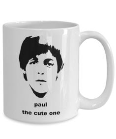 a white coffee mug with the image of paul the cute one in black on it