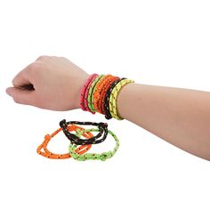 a person's arm with four bracelets on it and one is holding the other