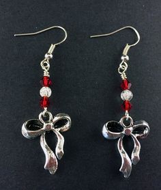 "Antique Silver Ribbon and Bow Earrings with Red and Clear Swarovski Crystals, Festive Holiday Jewelry, Simple Silver and Red Ribbon Earrings Special Holiday Earrings, perfect for gifts and seasonal jewelry Silver Tone Zinc metal alloy(Cadmium Free) Earring Size: ~1.75\" x 3/4\" All Aspen Tree Jewelry is made and stored in a smoke free environment and comes gift wrapped." Red Jewelry For Pierced Ears As A Gift, Metal Crystal Earrings For Valentine's Day Gift, Red Crystal Metal Party Earrings, Red Metal Crystal Party Earrings, Red Crystal Metal Earrings For Parties, Handmade Red Crystal Earrings For Gift, Red Metal Earrings For Party, Red Holiday Earrings With Ear Wire, Holiday Red Ear Wire Earrings