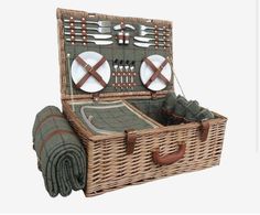 a wicker picnic basket with utensils in it