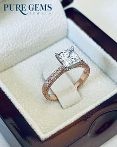 an engagement ring with a princess cut diamond in a box