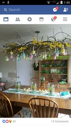 an image of a dining room table decorated with easter eggs and flowers hanging from the ceiling