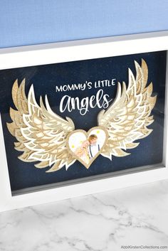 an angel's wings frame with the words mommy's little angels in it