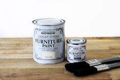 a can of furniture paint next to two brushes