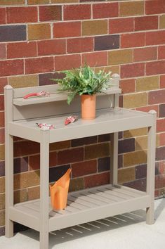 an outdoor shelf with potted plants next to a red brick wall and white tile floor