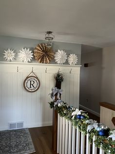 christmas decorations are hanging on the wall next to a radiator