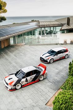 two cars parked next to each other in front of a house