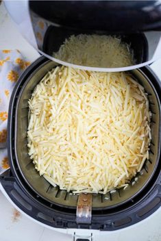 shredded cheese is in an air fryer and ready to be cooked