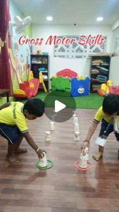 two children playing with plastic cups in a room