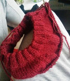 a red knitted purse sitting on top of a woman's shoulder