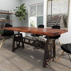 a wooden table sitting next to two black chairs