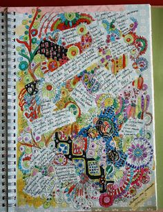 a spiral notebook covered in lots of different types of letters and numbers on the cover