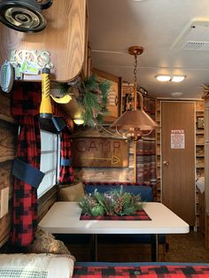 the interior of a camper with wood paneling and plaid decor on the walls