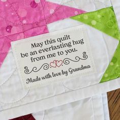 a close up of a patchwork quilt with a quote on the front and back