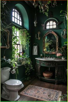 a bathroom with green walls and plants on the window sill, toilet and sink