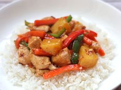 a white plate topped with rice and chicken