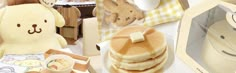 there are many items on the table including pancakes and stuffed animals, such as a teddy bear