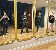 a group of people standing in front of a mirror