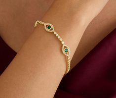 💎 TheEmerald Tennis Evil Eye bracelet is decorated with zircon stones and designed with great quality and elegance.  💎 It will make you feel good with its quality. You will feel that you are attracting positive energies.  💎 The bracelet is also perfect for gifting to your loved ones. We wrap it as gift wrap for you. 💎TECHNİCAL INFORMATION💎 There are 3 large evil eye emerald zircon stones. It comes with a 2 inch extension. Our bracelet is 16 cm (6.2 inches.)  Made of premium quality 925 ster Elegant Evil Eye Bracelet, Elegant Gold Evil Eye Bracelet With Cubic Zirconia, Green Diamond Bracelet With Accents As Gift, Ring Holder Necklace, Bracelet Tennis, Eye Bracelet, Evil Eye Bracelet, Evil Eye, Arm Band