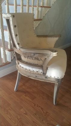 an old chair sitting in front of a stair case