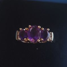 R306 $199 Size 7 Amethyst Ring With Diamonds 10k Yellow Gold. Three Lovely Oval Amethysts Set In Polished 10k Yellow Gold Gracefully Accented With .1ctw Round Diamonds. Est Retail $299 Oval Amethyst Jewelry With Diamond Accents, 14k Gold Purple Jewelry For Anniversary, Purple 14k Stamped Ring, Purple 14k Gold Jewelry For Anniversary, Heirloom 14k Stamped Amethyst Jewelry, 14k Gold Purple Ring Jewelry, Purple Oval 14k Stamped Jewelry, 14k Gold Purple Ring With Diamond Accents, 14k Gold Jewelry With Purple Accent Stones