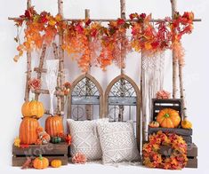 an arrangement of pumpkins and gourds in front of a window