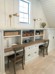 a room with two desks and some chairs