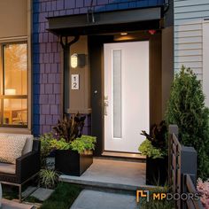 the front door of a house with plants and chairs