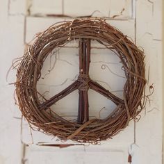 a peace sign made out of twigs hanging on a wall