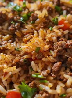 a close up of rice with meat and vegetables