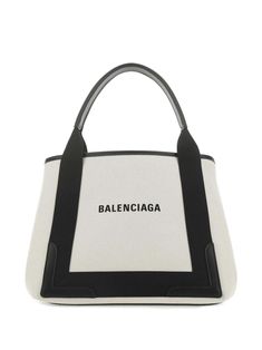 Balenciaga's compact Cabas S tote is an essential accessory for the new season. Designed to withstand the seasons, the white and navy colourway will remain perennially stylish. Benefiting from multiple ways to wear thanks to the rounded top handles, this medium-sized Cabas tote is finished with a printed logo across the front and an internal zipped logo pouch. Large White Luxury Bag, Large White Bag With Top Carry Handle, Elegant Large White Bag, Medium White Shoulder Bag For Travel, Balenciaga Bag, The Seasons, New Season, Bag Making, Medium Size