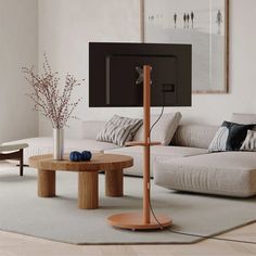 a living room with a couch, coffee table and flat screen tv on the wall