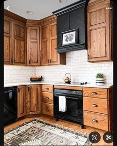 a kitchen with wooden cabinets and black appliances