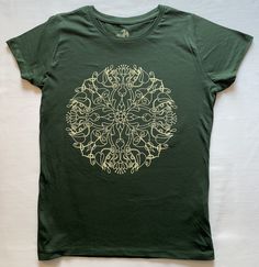 "Originally drawn by hand on paper. High quality screen print on 100% organic cotton T shirt. Ladies Mandala T shirt, 100% organic cotton 150gsm side seamed for a fitted look, 100% OCS Organic ring-spun Combed Cotton for a super soft feel. Size Chest (to fit): S - 34-36\" // M - 36-38\" // L - 38-40\" Note the colour may look slightly different from actual item depending on your computers monitor and settings. Dispatched in packaging which can be recycled or composted." Eco-friendly Green Cotton T-shirt, Eco-friendly Green Crew Neck T-shirt, Green Eco-friendly Crew Neck T-shirt, Hand Printed Organic Cotton T-shirt, Relaxed Fit, Hand Printed Organic Cotton T-shirt In Relaxed Fit, Hand Printed Relaxed Fit Organic Cotton T-shirt, Green Organic Relaxed Fit T-shirt, Green Organic Cotton T-shirt With Screen Print, Hand Printed Organic Cotton Crew Neck T-shirt